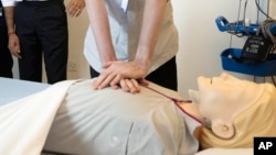 FILE - CPR is demonstrated during a tour of Addenbrooke's Hospital in Cambridge, England, June 30, 2023. Researchers have found that bystanders are less likely to administer potentially life-saving CPR to women than men.