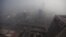 Buildings and the Guomao Bridge are pictured amid heavy haze and smog in Beijing, October 29, 2011. 