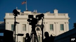 FILE - Journalists gather outside the White House, in Washington, Nov. 4, 2020. 