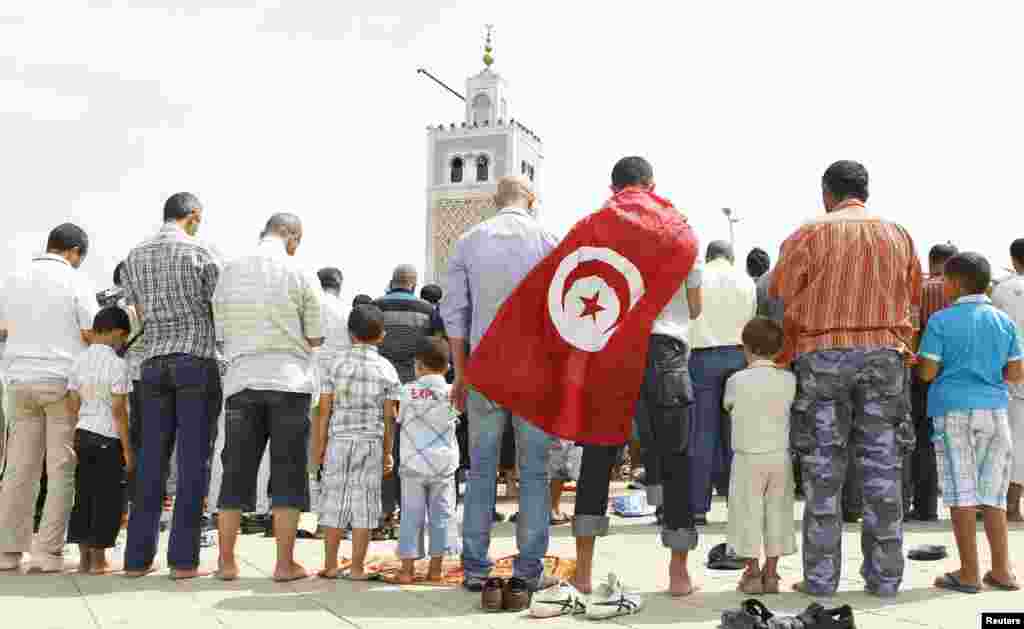 People attend Friday prayers during a demonstration in support of the ruling party Ennahda, in Tunis August 31, 2012. 