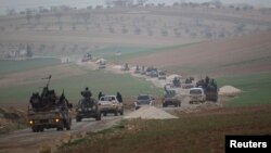 FILE - Members of al Qaida's Nusra Front drive in a convoy as they tour villages, which they said they have seized control of from Syrian rebel factions, Dec. 2, 2014.