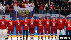 The Russian team sings their national anthem while wearing their gold medals.