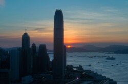 The skyline of the business district is silhouetted at sunset in Hong Kong, July 13, 2020.