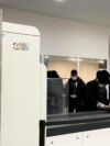 FILE - Passengers walk next to Nuctech security scanners at the Brussels Eurostar train terminal on Monday, Jan. 17, 2022. 