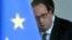 French President Francois Hollande is seen through the glass door after a security meeting at the Elysee palace in Paris, Nov. 14, 2015.