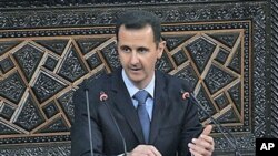 Syrian President Bashar al-Assad addresses the nation during a speech at the Parliament in Damascus, Syria, March 30, 2011