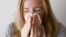 FILE: Representative illustration of a woman sneezing / blowing her nose. Taken Aug. 19, 2020.