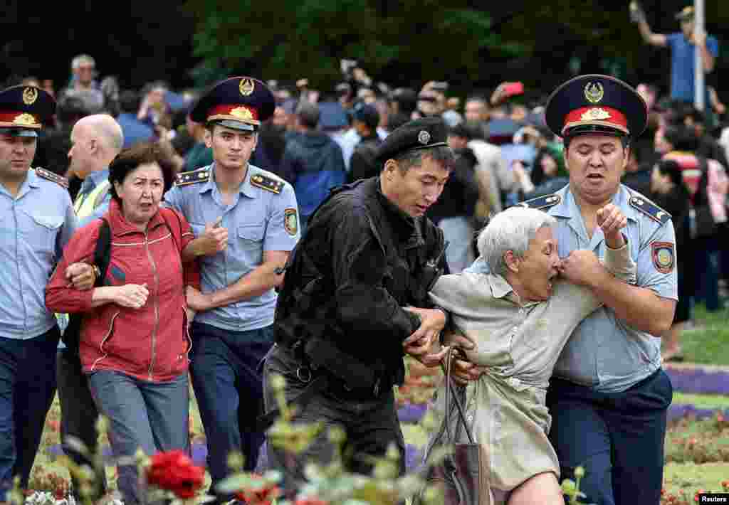 Police officers detain opposition supporters during a protest against the presidential election, in Almaty, Kazakhstan.