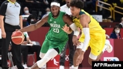 Mchezaji wa Nigeria Josh Okogie kushoto akimpita Matisse Thybulle wa Australia katika mchezo wao wa mchuano wa Olimpiki huko Tokyo Japan Jumapili July 25.