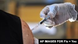 A senior adult receives a flu vaccine, Sept. 6, 2013 at the Williams YMCA in Jacksonville, Fla. 