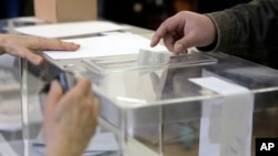 Voter casts his vote at a polling station in Sofia, April 2, 2023.