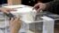 Voter casts his vote at a polling station in Sofia, April 2, 2023.