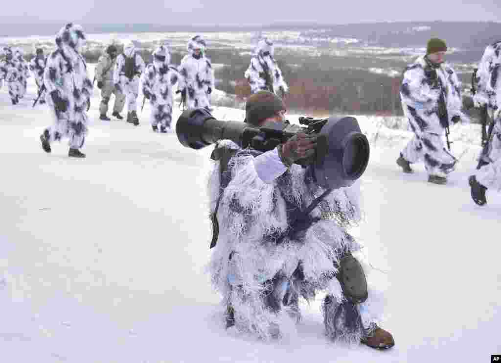 Soldiers take part in an exercise for the use of NLAW anti-aircraft missiles at the Yavoriv military training ground, close to Lviv, western Ukraine.