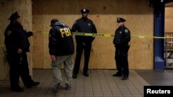 FILE - A member of the FBI enters a crime scene beneath the New York Port Authority Bus Terminal, in New York, Dec. 11, 2017. 