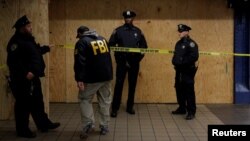 A member of the FBI enters the crime scene beneath the New York Port Authority Bus Terminal following an attempted detonation during the morning rush hour, in New York City, New York, Dec. 11, 2017. 