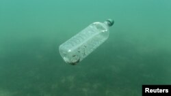 FILE - A plastic bottle floats in the Adriatic Sea off the island Mljet, Croatia, May 30, 2018. 