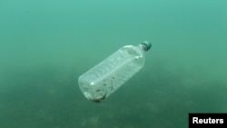 FILE - A plastic bottle floats in the Adriatic Sea off the island of Mljet, Croatia, May 30, 2018. 