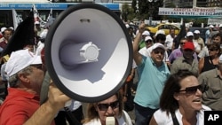 Employees of the state-owned company Hellenic Defence Systems, protest outside the Greek parliament against the privatization of the company, June 21, 2011