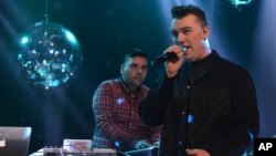 FILE - Naughty Boy and Sam Smith record 'La La La' for BBC 1's Christmas Day Special in London on Dec. 7, 2013. 