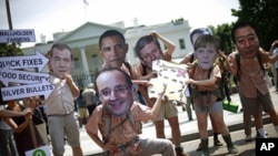 Activists wearing masks depicting G8 world leaders participate in a demonstration outside the White House in Washington, May 17, 2012. (AP)