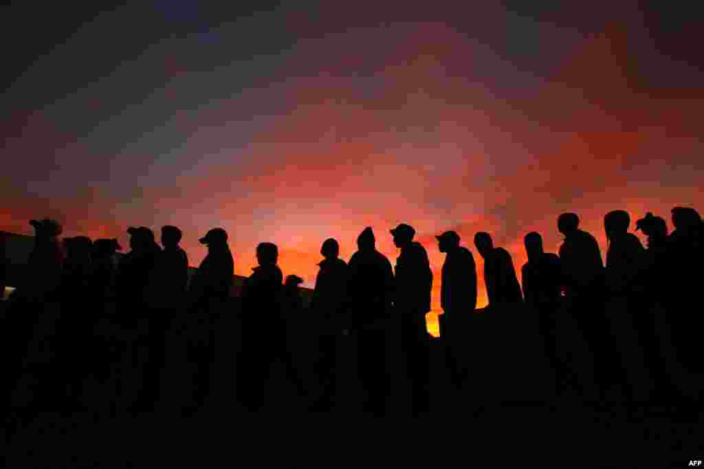 May 18: Early morning voters wait to cast their votes during the South African municipal elections in Cape Town. (Reuters)