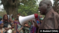 FILE - Ibrahim Abaka, the president of an internally displaced persons camp, uses a megaphone to organize the distribution of food aid in Bambari, Central African Republic, January 2017.