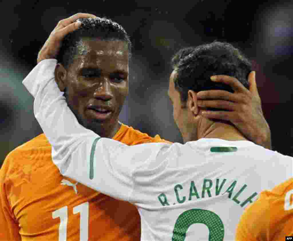 Ivory Coast's Didier Drogba, left, greets Portugal's Ricardo Carvalho at the end of the World Cup group G soccer match between Ivory Coast and Portugal at Nelson Mandela Bay Stadium in Port Elizabeth, South Africa, Tuesday, June 15, 2010. The game ended 