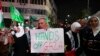 FILE - Supporters of the Fatah and Hamas movments lift placards and flags as they march in Hebron city in the occupied West Bank on October 11, 2023, to protest the Israeli bombardment of the Gaza Strip.