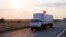 A convoy of white trucks carrying humanitarian aid passes along the main road M4 (Don highway) Voronezh region, Russia, Aug. 12, 2014
