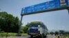 FILE - An Indian bus carrying passengers who arrived from the Pakistani side of Kashmir leaves the border at Chakka Da Bagh in Poonch district, 250 kilometers northwest of Jammu, India.