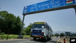 FILE - An Indian bus carrying passengers who arrived from the Pakistani side of Kashmir leaves the border at Chakka Da Bagh in Poonch district, 250 kilometers (156 miles) northwest of Jammu, India.