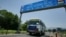 FILE - An Indian bus carrying passengers who arrived from the Pakistani side of Kashmir leaves the border at Chakka Da Bagh in Poonch district, 250 kilometers (156 miles) northwest of Jammu, India.