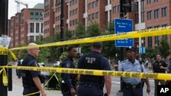 Police work the scene in Washington after a shooting at a Navy building in Washington, D.C.