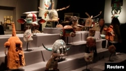 Antique tribal masks, revered as sacred ritual artifacts by the Hopi Native American tribe in Arizona, are displayed at an auction house in Paris, April 11, 2013. 