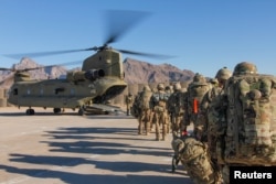 FILE - U.S. soldiers load onto a Chinook helicopter to head out on a mission in Afghanistan, Jan. 15, 2019.