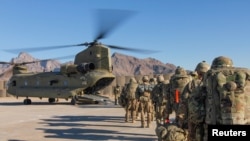 FILE - U.S. soldiers load onto a Chinook helicopter to head out on a mission in Afghanistan, Jan. 15, 2019.