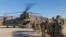 FILE - U.S. soldiers load onto a Chinook helicopter to head out on a mission in Afghanistan, Jan. 15, 2019.