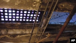 The view looking up to the sidewalk above from a utility room. Underground explorers look for clues like these to search for long forgotten underground chambers.