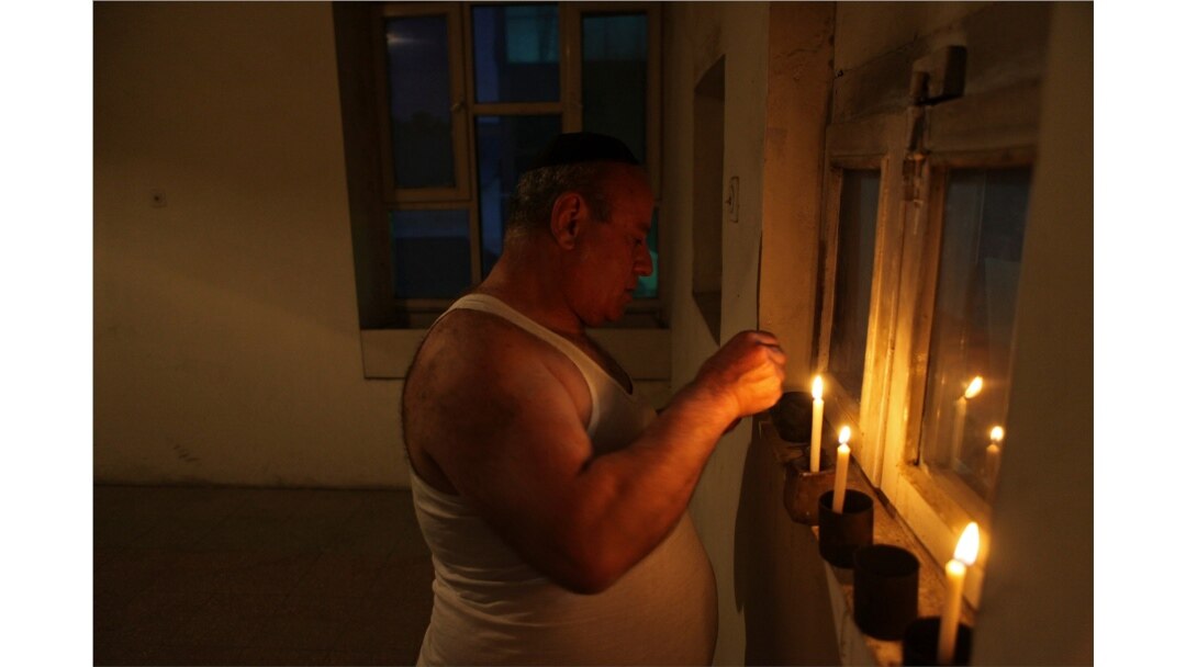 FILE - In this Aug. 29, 2009, photo, Zebulon Simentov, the last known Jew living in Afghanistan, lights the candles at the start of Shabbat in the synagogue he cares for in Kabul.