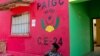 FILE - Dominga Lima, a member of the African Party for the Independence of Guinea and Cape Verde (PAIGC), sits in front of the party's logo at a campaign building in Bissau, Guinea-Bissau.