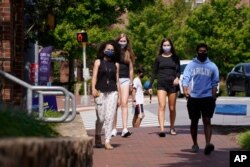 Students wear masks on campus at the University of North Carolina in Chapel Hill, N.C., Aug. 18, 2020.
