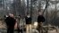 President Donald Trump talks with from left, Gov.-elect Gavin Newsom, California Gov. Jerry Brown, Paradise Mayor Jody Jones and FEMA Administrator Brock Longduring a visit to a neighborhood destroyed by the wildfires, Saturday, Nov. 17, 2018, in Calif.