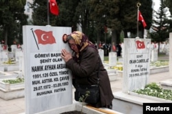 Pakize Akbaba mourns over the gravestone of her son Namik Ayhan Akbaba, a Turkish soldier who was killed during fighting with PKK militants, on the day jailed Kurdish militant leader Abdullah Ocalan called on the group to disarm and disband, in Istanbul, Turkey, on Feb. 27, 2025.