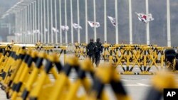 South Korean army soldiers walk by barricades set up on Unification Bridge near the border village of Panmunjom.