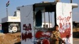 A Kurdish Peshmerga fighter stands at a checkpoint retaken from Islamic State militants in Barznki village in Zummar, near Mosul, Sept. 15, 2014.
