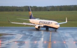 FILE - The Boeing 737-8AS Ryanair passenger plane that was intercepted and diverted to Minsk by Belarus authorities lands at Vilnius International Airport, its initial destination, in Lithuania, May 23, 2021.