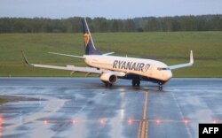 FILE - The Boeing 737-8AS Ryanair passenger plane that was intercepted and diverted to Minsk by Belarus authorities lands at Vilnius International Airport, its initial destination, in Lithuania, May 23, 2021.