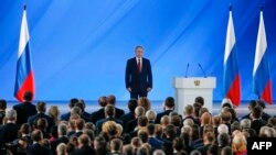 Russian President Vladimir Putin and officials listen to the national anthem after President's address to the Federal Assembly at the Manezh exhibition hall in downtown Moscow on January 15, 2020.