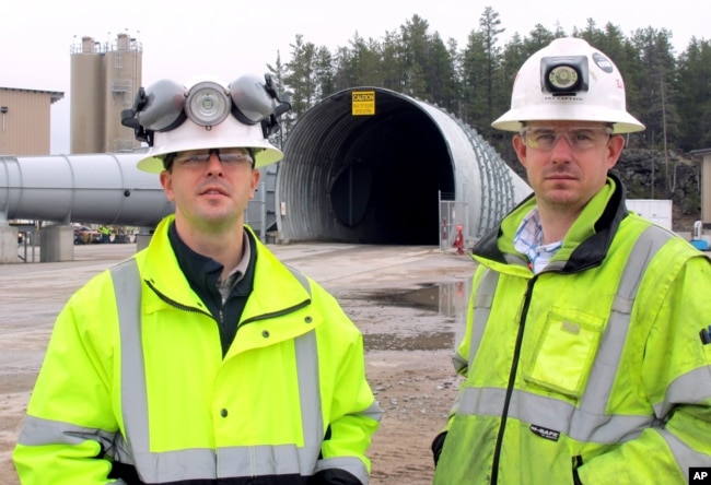 In this May 8, 2014 photo Eagle Mine advisors Dan Blondeau, left, and Andy Vaughn stand outside the mine's portal in Marquette, Mich. (AP Photo/John Flesher)