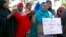Somali women listen to a speaker at a solidarity rally to denounce al Shabaab's attack of a shopping mall in Nairobi, in Minneapolis, Minnesota, Sept. 27, 2013. 